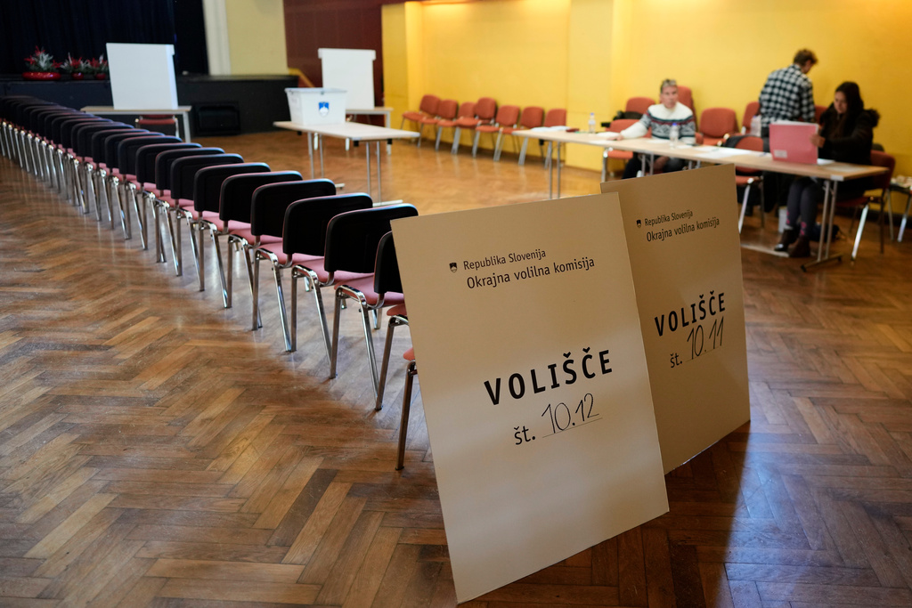 Commission wait for voters at a polling station during the referendum on assisted dying for terminally ill patients, in Domzale, Slovenia, Sunday, Nov. 23, 2025. (AP Photo/Darko Bandic)