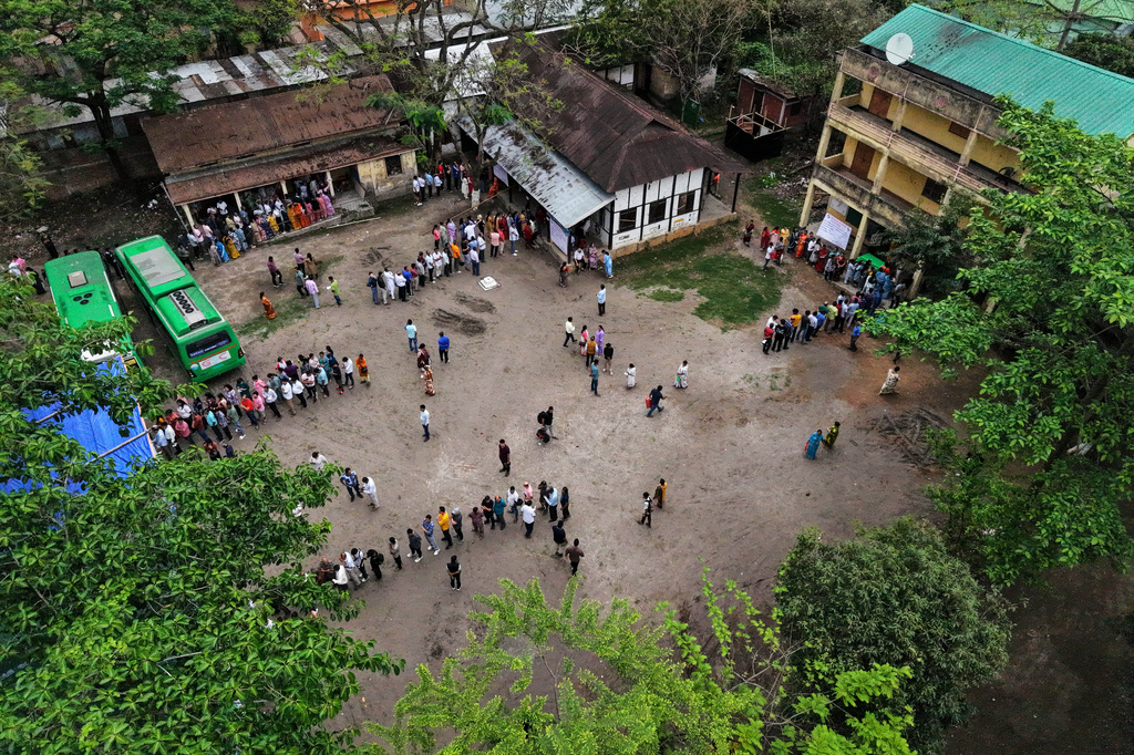 People stand in queue to cast their votes at a polling center during the state election in Guwahati, India, Thursday, April 9, 2026. (AP Photo/Anupam Nath)