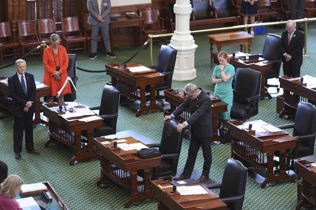 Texas state senators pray before they debate a bill on a redrawn U.S. congressional map during a special session in the Senate Chamber at the Texas Capitol in Austin, Texas, Friday, Aug. 22, 2025. (AP Photo/Eric Gay)
