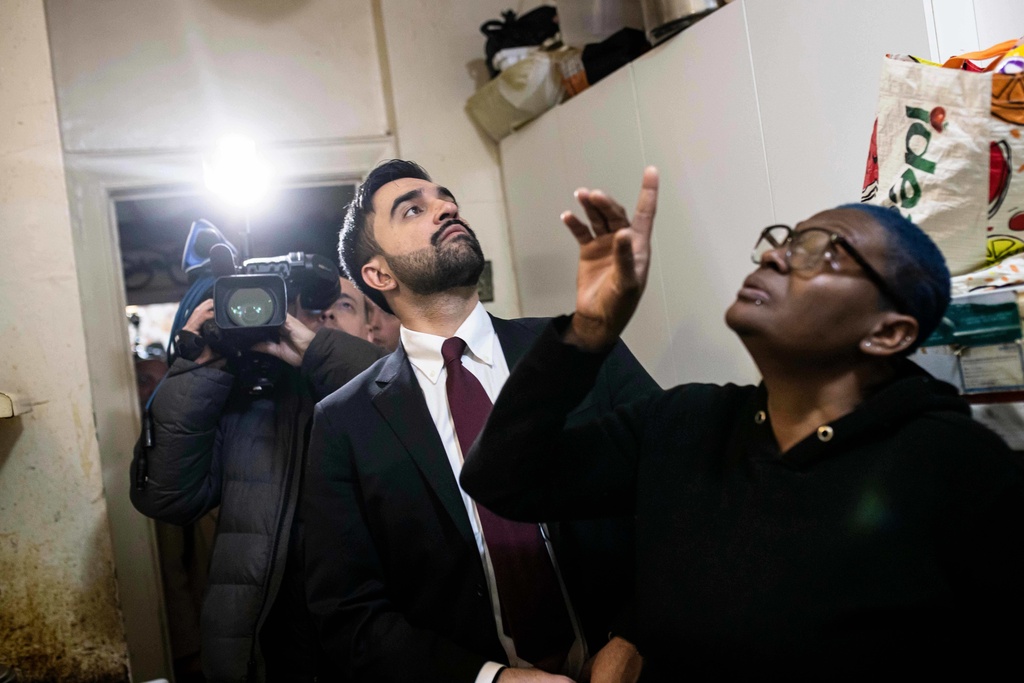 New York City Mayor Zohran Mamdani visits Nadege Romulus, right, in her apartment on Clarkson Avenue in the Prospect Lefferts Garden neighborhood of Brooklyn, in New York, on the first day in office, on Thursday, Jan. 1, 2026. (Dave Sanders/The New York Times, Pool via AP)