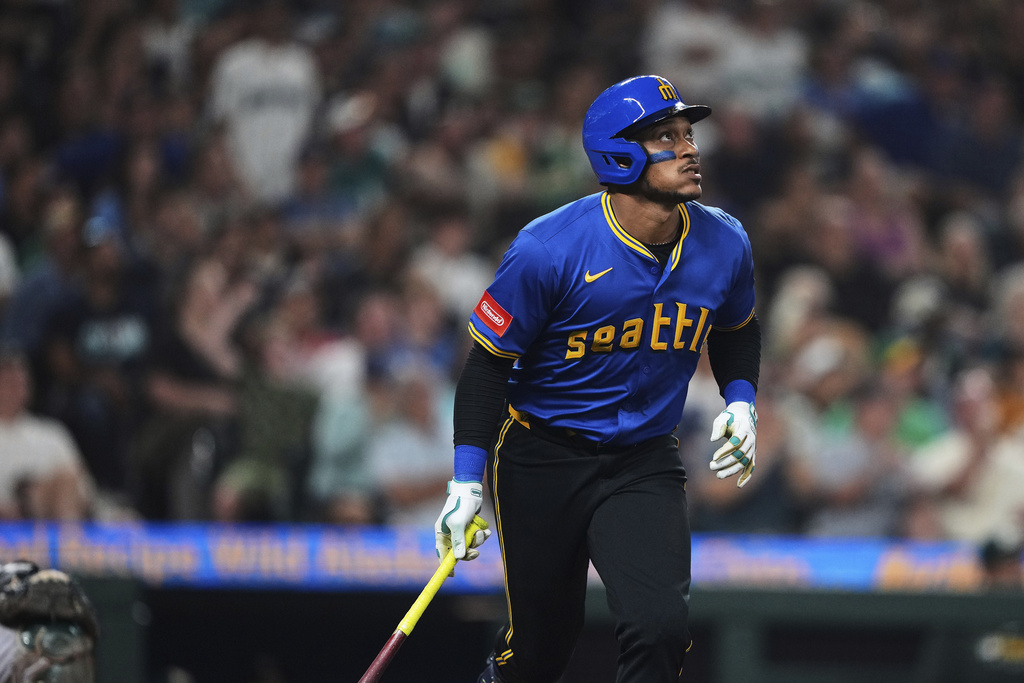 Seattle Mariners' Josh Naylor watches his solo home run off of Athletics pitcher Elvis Alvarado during the seventh inning of a baseball game Friday, Aug. 22, 2025, in Seattle. (AP Photo/Lindsey Wasson)