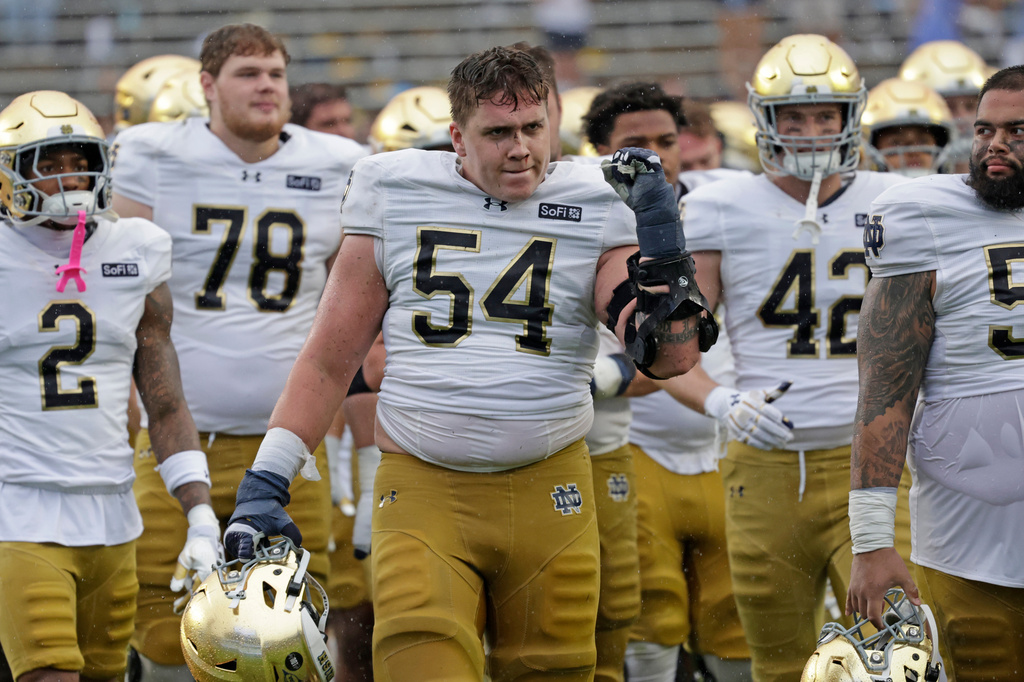 FILE - Notre Dame offensive lineman Anthonie Knapp (54) and his teammates celebrate after defeating North Carolina in an NCAA college football game, Oct. 3, 2026, in Chapel Hill, N.C. (AP Photo/Chris Seward, File)