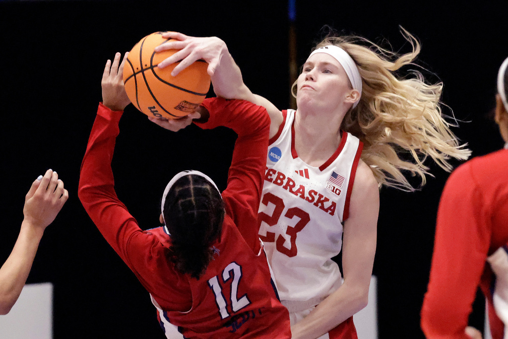 Nebraska guard Britt Prince (23) attempts to block a shot by Richmond guard Aneisha Scott (12) during the first half in a First Four college basketball game in the NCAA Tournament, Wednesday, March 18, 2026, in Durham, N.C. (AP Photo/Chris Seward)