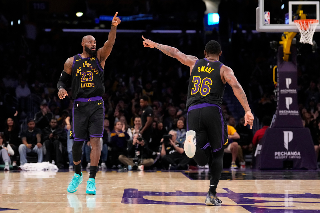 Los Angeles Lakers forward LeBron James, left, and guard Marcus Smart celebrate after Smart scored during the second half of an NBA basketball game against the Memphis Grizzlies, Friday, Jan. 2, 2026, in Los Angeles. (AP Photo/Mark J. Terrill)
