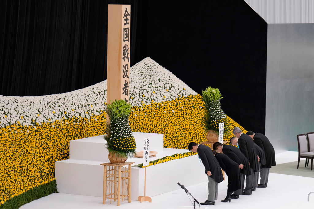 Japan's ministers bow during a memorial service marking the 80th anniversary of Japan's World War II defeat, at the Nippon Budokan hall Friday, Aug. 15, 2025, in Tokyo. (AP Photo/Eugene Hoshiko)