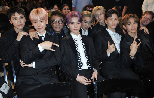 FILE - Producer Lee Soo Man, third from left, and members of SuperM, from left, Ten, Baekhyun, Taeyong, Kai, Taemin, Mark and Lucas sit in the audience to watch the premiere of their music video for their song "Jopping" during a media conference on Oct. 3, 2019, at Capitol Studios in Los Angeles. (Photo by Richard Shotwell/Invision/AP, File) FILE - Producer Lee Soo Man, third from left, and members of SuperM, from left, Ten, Baekhyun, Taeyong, Kai, Taemin, Mark and Lucas sit in the audience to watch the premiere of their music video for their song "Jopping" during a media conference on Oct. 3, 2019, at Capitol Studios in Los Angeles. (Photo by Richard Shotwell/Invision/AP, File)