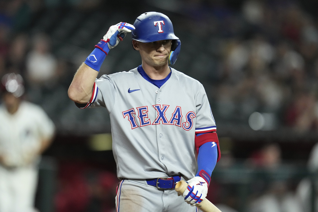 Texas Rangers' Michael Helman walks back to the dugout after being called out on strikes against the Arizona Diamondbacks during the ninth inning of a baseball game Tuesday, Sept. 2, 2025, in Phoenix. (AP Photo/Ross D. Franklin)