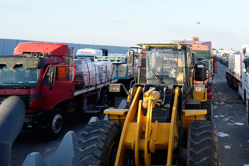 Bulldozers and trucks line up to enter the Egyptian gate of the Rafah crossing, heading for inspection by Israeli authorities before entering the Gaza Strip, following an agreement between Israel and Hamas on a ceasefire, Sunday, Oct. 26, 2025. (AP Photo/Mohamed Arafat) Bulldozers and trucks line up to enter the Egyptian gate of the Rafah crossing, heading for inspection by Israeli authorities before entering the Gaza Strip, following an agreement between Israel and Hamas on a ceasefire, Sunday, Oct. 26, 2025. (AP Photo/Mohamed Arafat)