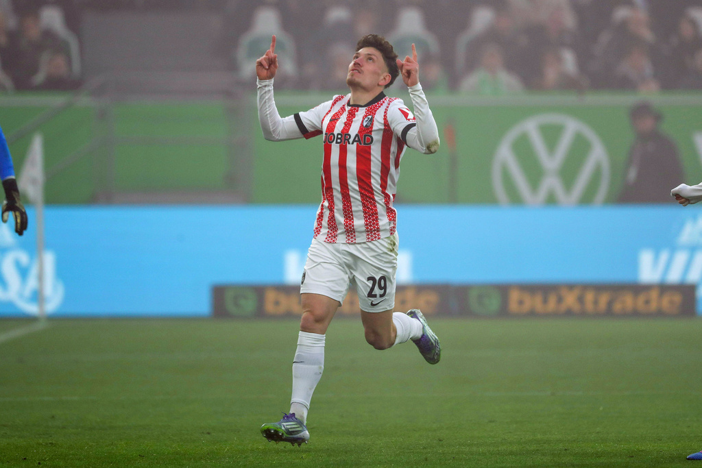 Freiburg's Philipp Treu celebrates after scoring the opening goal during the German Bundesliga soccer match between VfL Wolfsburg and SC Freiburg in Wolfsburg, Germany, Saturday, Dec. 20, 2025. (Darius Simka/dpa via AP)