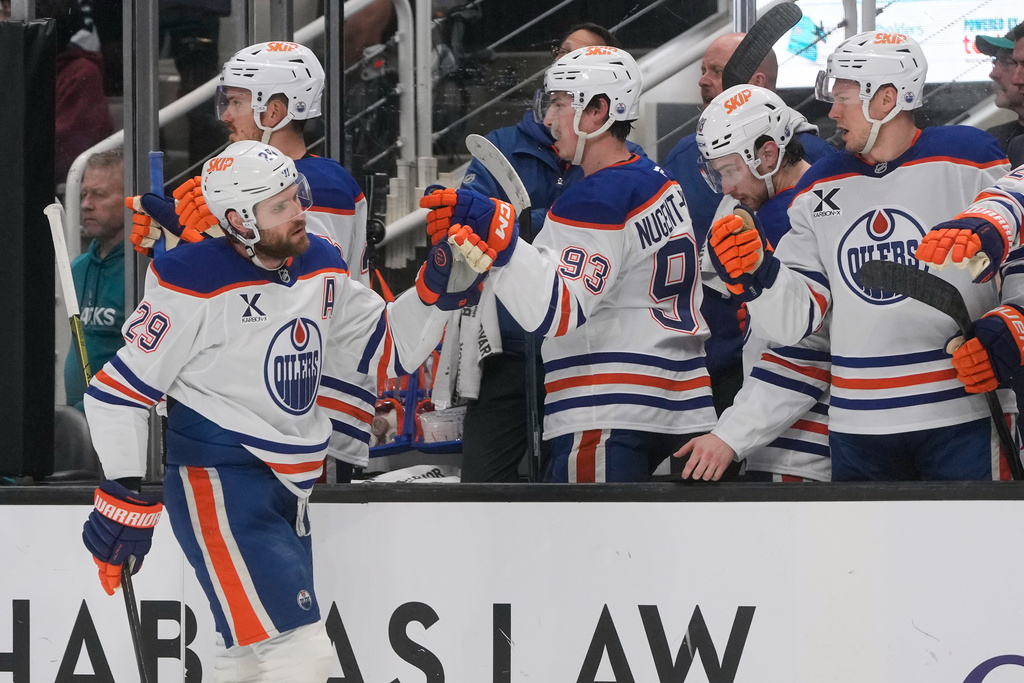Edmonton Oilers center Leon Draisaitl (29) is congratulated by teammates after scoring against the San Jose Sharks during the first period of an NHL hockey game in San Jose, Calif., Saturday, Feb. 28, 2026. (AP Photo/Jeff Chiu)