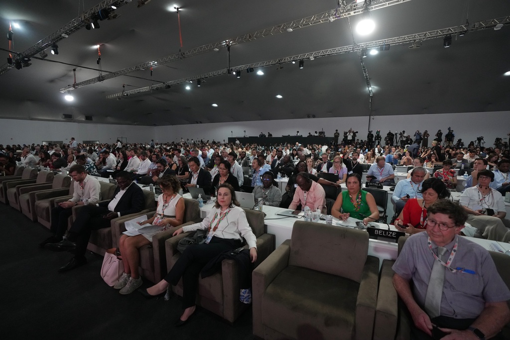 Attendees listen as André Corrêa do Lago, COP30 president, speaks during a plenary session at the COP30 U.N. Climate Summit, Saturday, Nov. 22, 2025, in Belem, Brazil. (AP Photo/Fernando Llano)