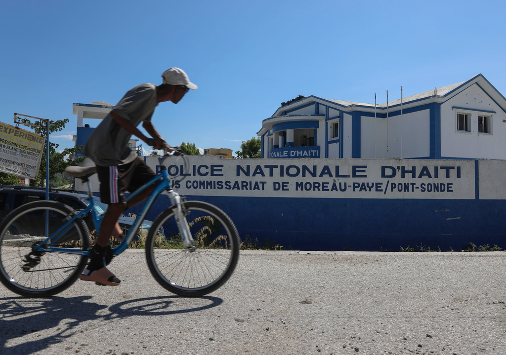 FILE - A man rides his bicycle past police station in Pont-Sonde, Haiti, Oct. 7, 2024. (AP Photo/Odelyn Joseph, File)