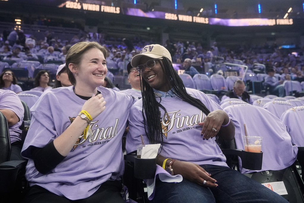 Golden State Valkyries fans Kendall Christmas-Miller, left, smiles with her wife, Shaunice Christmas-Miller, while being interviewed before Game 5 of the WNBA basketball finals between the Valkyries and the Atlanta Dream, Monday, Oct. 26, 2026, in San Francisco. (AP Photo/Jeff Chiu)