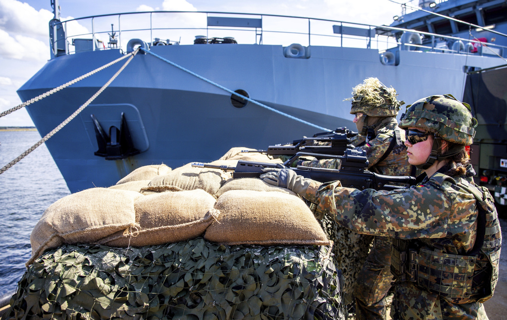 Soldiers of the German forces, Bundeswehr, secure the port at the start of Media Day as part of the 'Quadriga 2025' military maneuver in Rostock, Germany, Thursday, Sept. 4, 2025. (Jens Buettner/dpa via AP)