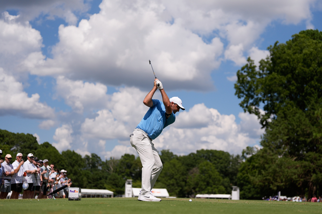 Scottie Scheffler hits from the 14th tee during the third round of the St. Jude Championship golf tournament Saturday, Aug. 9, 2025, in Memphis, Tenn. (AP Photo/George Walker IV)
