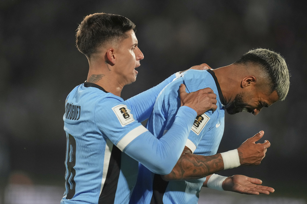 Uruguay's Rodrigo Aguirre, right, celebrates after scoring the opening goal against Peru during a World Cup 2026 qualifying soccer match in Montevideo, Uruguay, Thursday, Sept. 4, 2025. (AP Photo/Matilde Campodonico)