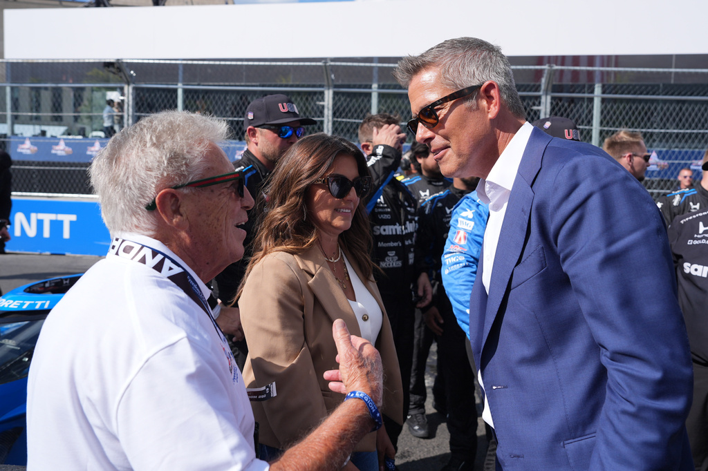 Transportation Secretary Sean Duffy talks with Mario Andretti after Kyle Kirkwood (27) won the IndyCar Freedom 250 Grand Prix auto race in Washington, Sunday, Aug. 23, 2026. (AP Photo/Alex Brandon)