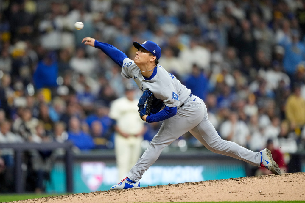 Los Angeles Dodgers pitcher Yoshinobu Yamamoto throws against the Milwaukee Brewers during the eighth inning in Game 2 of baseball's National League Championship Series, Tuesday, Oct. 14, 2025, in Milwaukee. (AP Photo/Brynn Anderson)