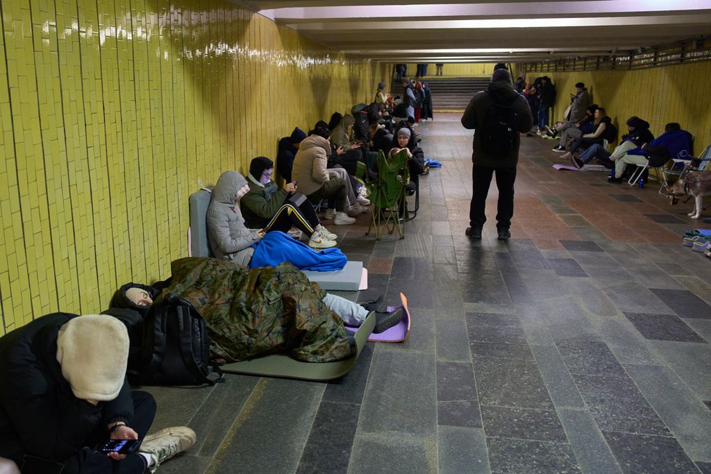 People hide in an underground pedestrian crossing during Russia's night missile and drone attack in Kyiv, Ukraine, Saturday, Nov. 29, 2025. (AP Photo/Efrem Lukatsky)
