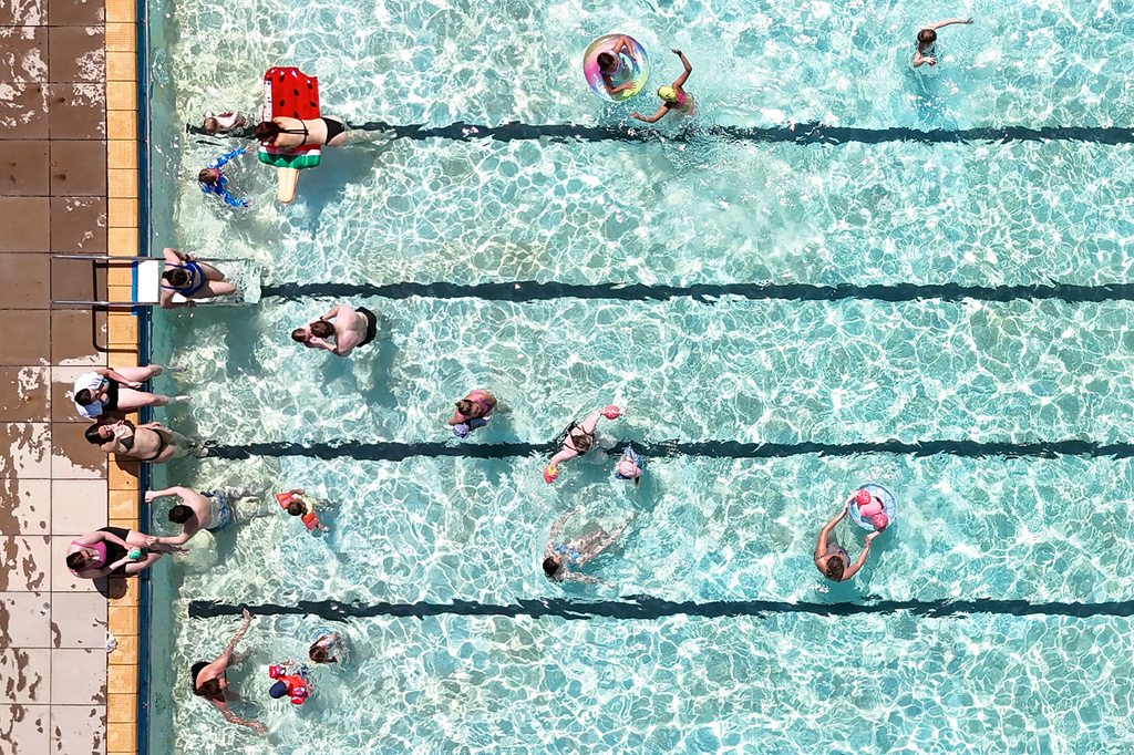 Swimmers keep cool in the hot weather in an open-air pool in Letchworth Garden City, Hertfordshire, England, Tuesday May 26, 2026. (Joe Giddens/PA via AP)