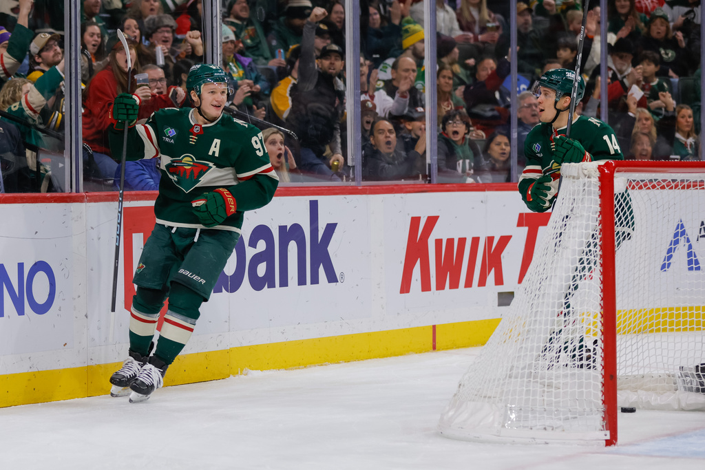 Minnesota Wild left wing Kirill Kaprizov (97) celebrates with center Joel Eriksson Ek (14) after scoring during the second period of an NHL hockey game against the Boston Bruins, Sunday, Dec. 14, 2025, in St. Paul, Minn. (AP Photo/Bailey Hillesheim)
