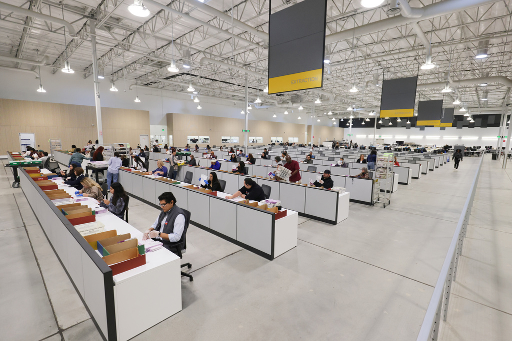 Workers sort through ballots at the L.A. County Ballot Processing Center on Tuesday, Nov. 4, 2025, in City of Industry, Calif. (AP Photo/Ethan Swope)