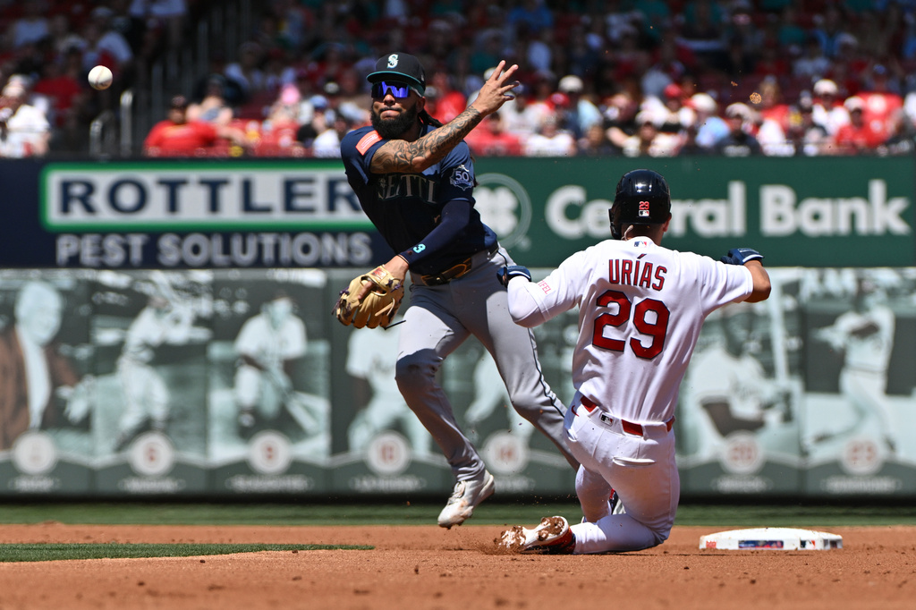 St. Louis Cardinals' Ramón Urías (29) is out as Seattle Mariners shortstop J.P. Crawford, left, throws to first to complete the double play against Victor Scott II during the second inning of a baseball game, Sunday, April 26, 2026, in St. Louis. (AP Photo/Jeff Le)