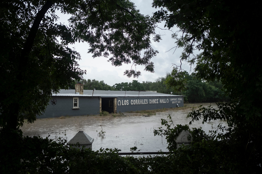 Los Corrales Dance Hall along State Highway 27 is flooded on Thursday, July 16, 2026, in Comfort, Texas. (AP Photo/Joel Angel Juarez)