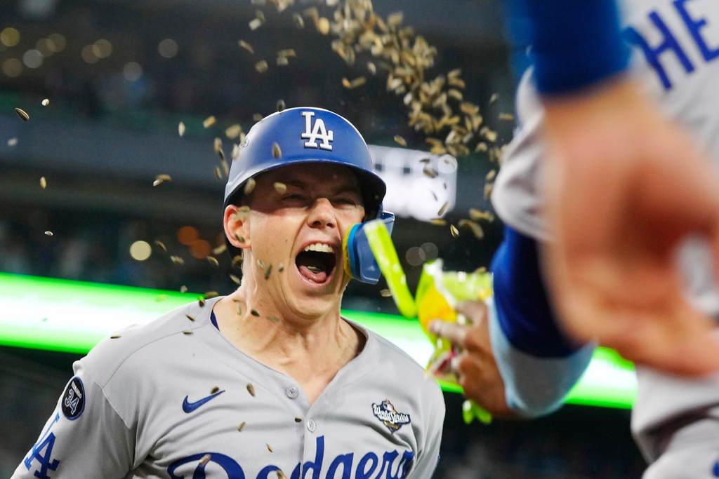 Los Angeles Dodgers' Will Smith (16) celebrates after hitting a solo home run against the Toronto Blue Jays during the 11th inning in Game 7 of baseball's World Series against the Toronto Blue Jays in Toronto on Sunday, Nov. 2, 2025. (Frank Gunn/The Canadian Press via AP)