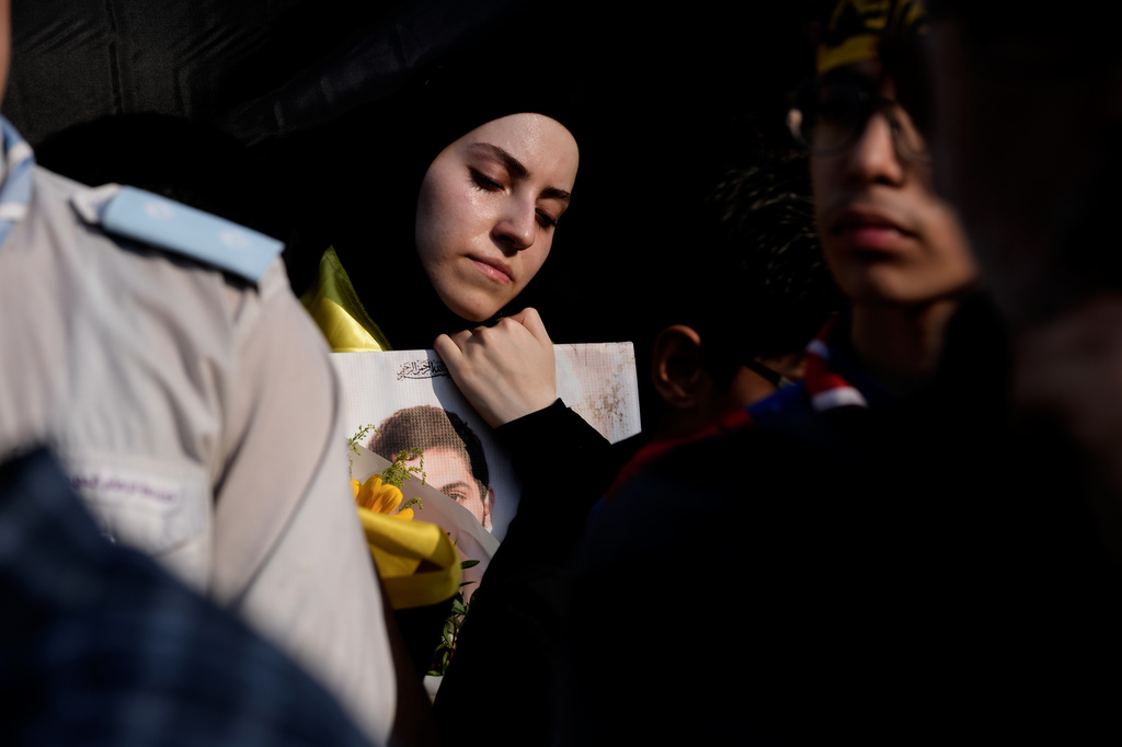 A woman mourns during the funeral of Hezbollah member Ali al-Haj Hassan, his wife and four children who were killed the previous day by an Israeli airstrike, in the southern suburb of Beirut, Lebanon, Sunday, Aug. 16, 2026. (AP Photo/Hussein Malla)