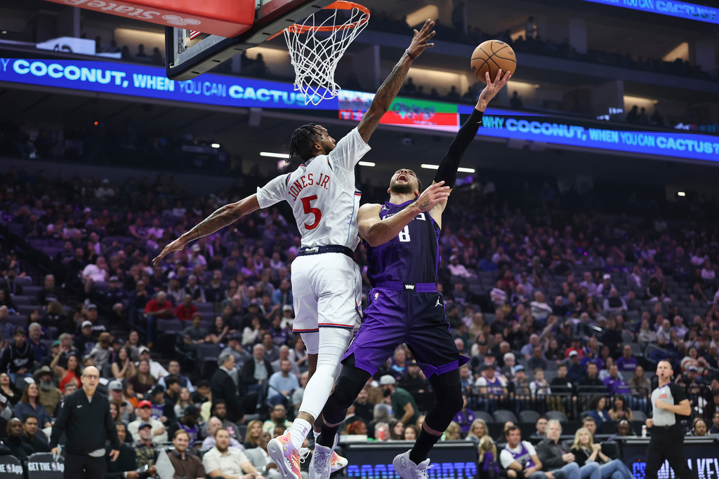Sacramento Kings guard Zach LaVine (8) draws the foul on Los Angeles Clippers forward Derrick Jones Jr. (5) during the first half of an NBA basketball game Friday, Feb. 6, 2026, in Sacramento, Calif. (AP Photo/Sara Nevis)