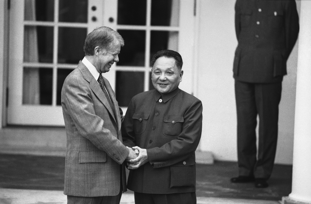FILE - Then U.S. President Jimmy Carter and then Chinese Vice Premier Teng Hsiao-ping hold hands outside the Oval Office of the White House in Washington on Jan. 30, 1979 as they met for the third time in two days for talks. (AP Photo, File)