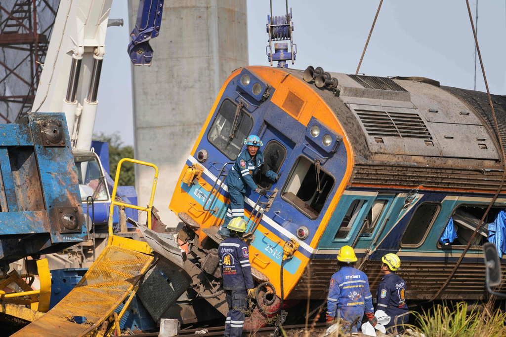 Rescuers work amidst the wreckage after a construction crane fell into a passenger train in Nakhon Ratchasima province, Thailand, Wednesday, Jan.14, 2026. (AP Photo/Sakchai Lalit))