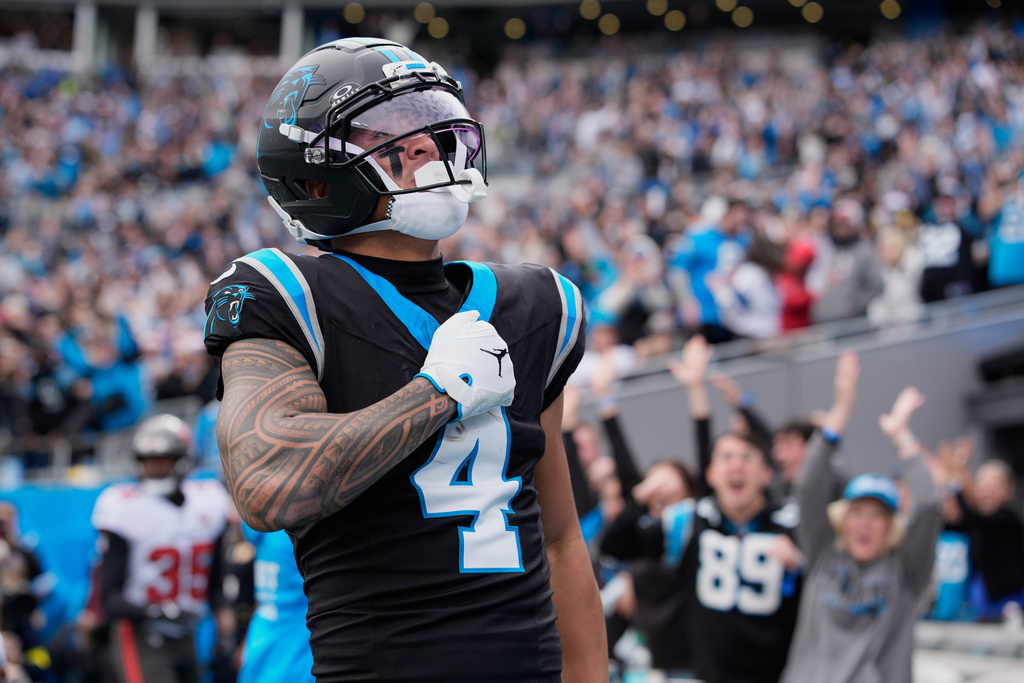 Carolina Panthers wide receiver Tetairoa McMillan celebrates after scoring against the Tampa Bay Buccaneers during the first half of an NFL football game, Sunday, Dec. 21, 2025, in Charlotte, N.C. (AP Photo/Jacob Kupferman)