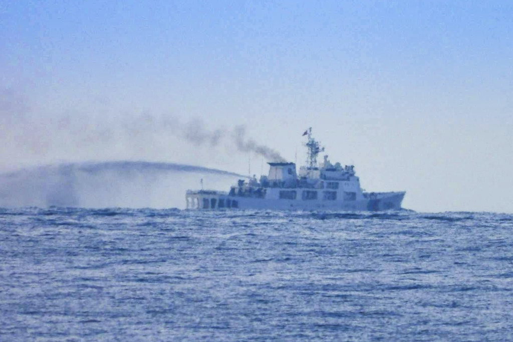 In this photo provided by the Armed Forces of the Philippines, Public Information Office (PAO), a China Coast Guard Vessel conducts apparent water cannon drill close to long-grounded Philippine warship BRP Sierra Madre in the vicinity of Second Thomas Shoal at the disputed South China Sea on Wednesday August 20, 2025. (Armed Forces of the Philippines PAO via AP)