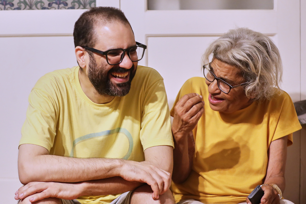 Pro-democracy activist Alaa Abd el-Fattah, left, who was in prison for almost all of the past 12 years, listens to his mother Laila Soueif, after a presidential pardon at his home in Cairo, Tuesday, Sept. 23, 2025. (AP Photo/Khaled Elfiqi)