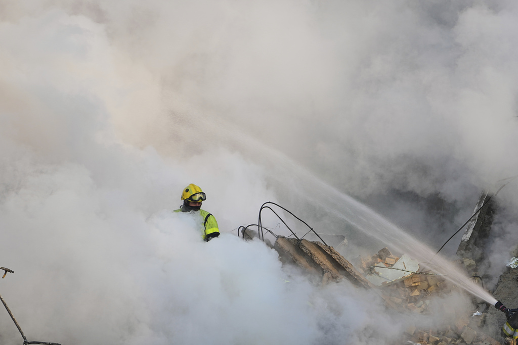 Firefighters work at the site of a burning building after a Russian attack in Kyiv, Ukraine, Thursday, Aug. 28, 2025. (AP Photo/Efrem Lukatsky)