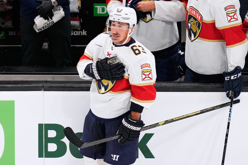 Florida Panthers left wing Brad Marchand (63), who played for more than 15 seasons with the Boston Bruins, taps his heart during a standing ovation during a break in the first period of an NHL hockey game, Tuesday, Oct. 21, 2025, in Boston. (AP Photo/Charles Krupa) Florida Panthers left wing Brad Marchand (63), who played for more than 15 seasons with the Boston Bruins, taps his heart during a standing ovation during a break in the first period of an NHL hockey game, Tuesday, Oct. 21, 2025, in Boston. (AP Photo/Charles Krupa)