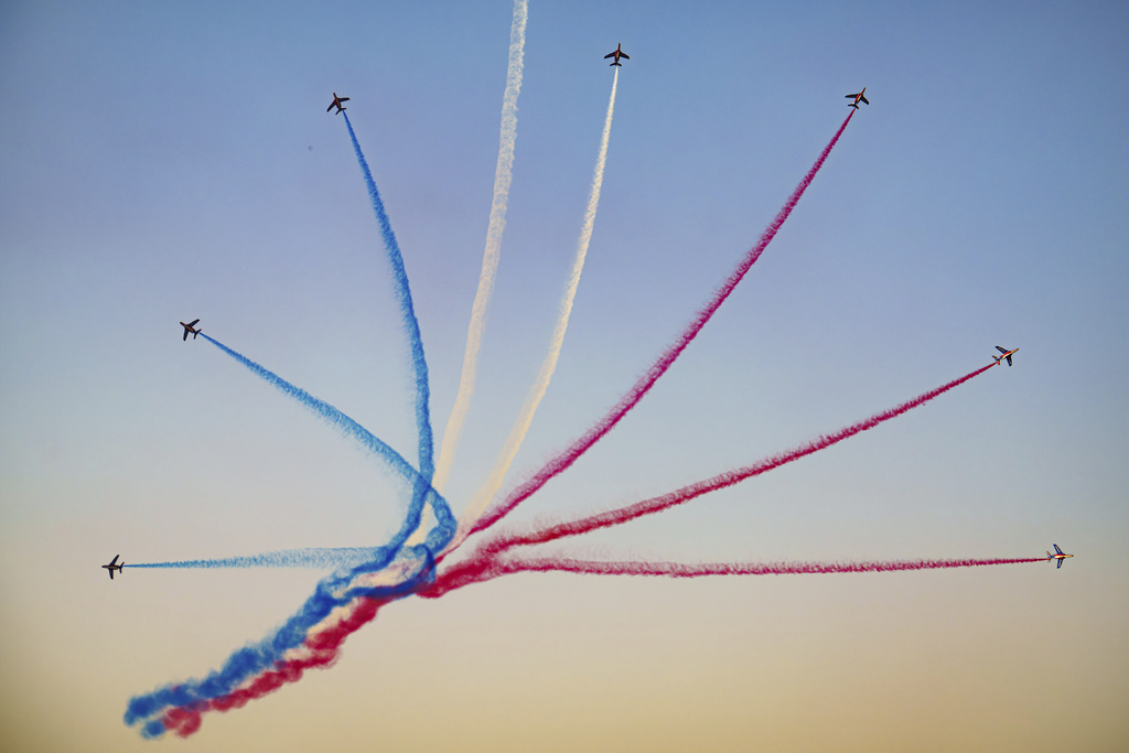 Pilots of the Patrouille de France (PAF), the precision aerobatics unit of the French Air and Space Force, perform above the runway of the Aurel Vlaicu airport, on the first day of the Bucharest International Air Show, BIAS 2025 in Bucharest, Romania, Saturday, Aug. 30, 2025. (AP Photo/Andreea Alexandru)