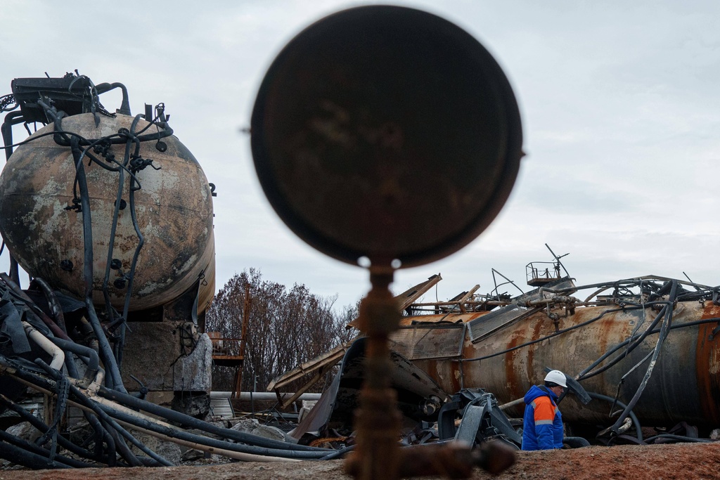 Victor, Naftogaz worker walks in front of a Naftogaz gas extraction facility destroyed by a Russian strike in Ukraine, on Tuesday, Nov. 18, 2025. (AP Photo/Evgeniy Maloletka)