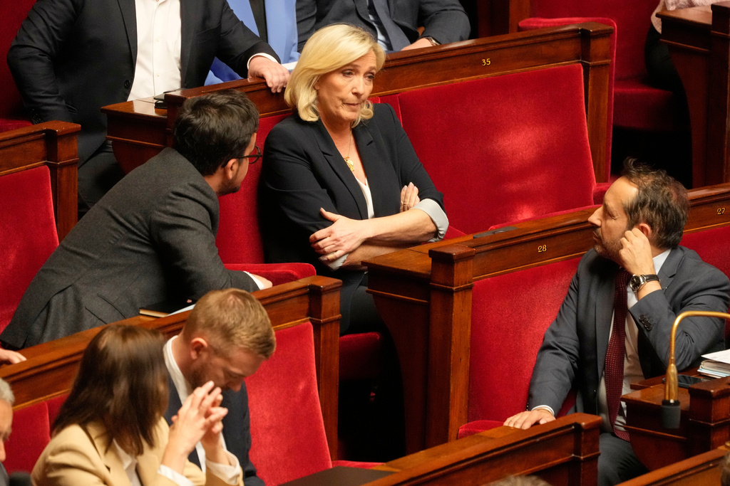 FILE - French far-right leader Marine Le Pen, center, reacts at the National Assembly during a session, on April 1, 2025 in Paris. (AP Photo/Michel Euler, File)