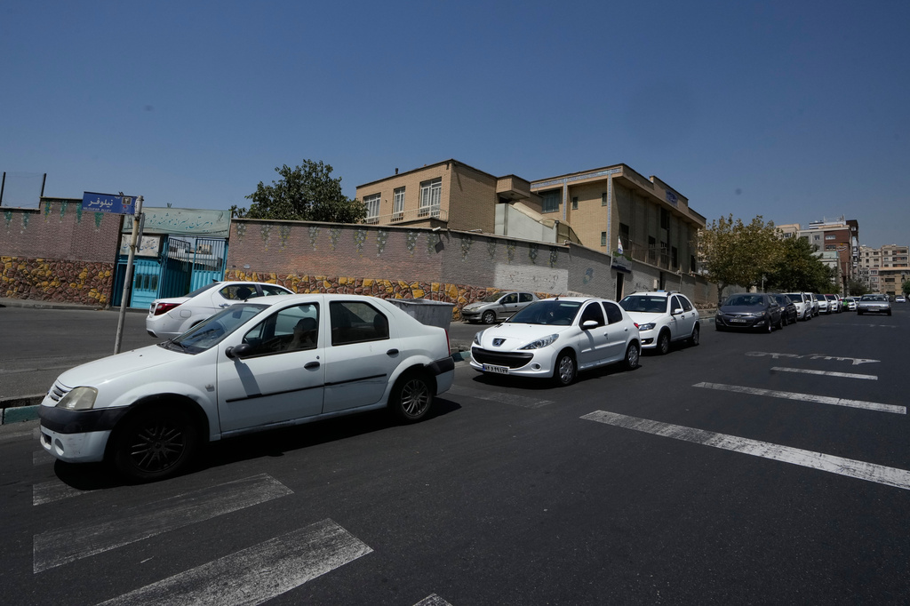 Cars line up outside a gas station in Tehran, Iran, Tuesday, Aug. 25, 2026. (AP Photo/Vahid Salemi)