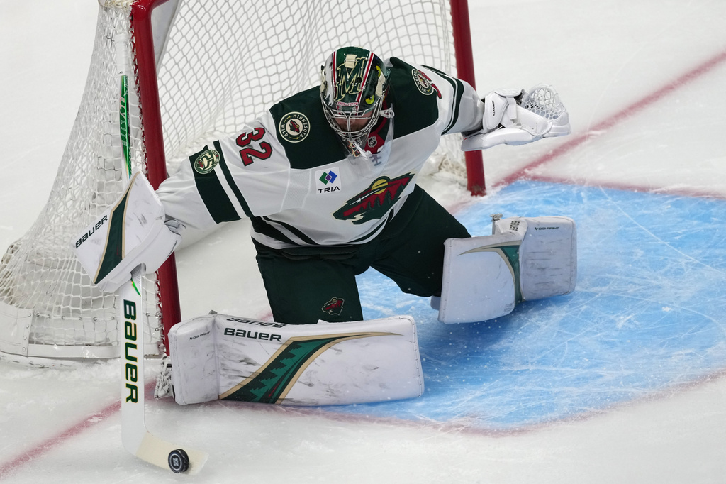 Minnesota Wild goaltender Filip Gustavsson makes a stick save of a shot by the Colorado Avalanche in the first period of Game 2 of an NHL hockey Stanley Cup second-round playoff series Tuesday, May 5, 2026, in Denver. (AP Photo/David Zalubowski)
