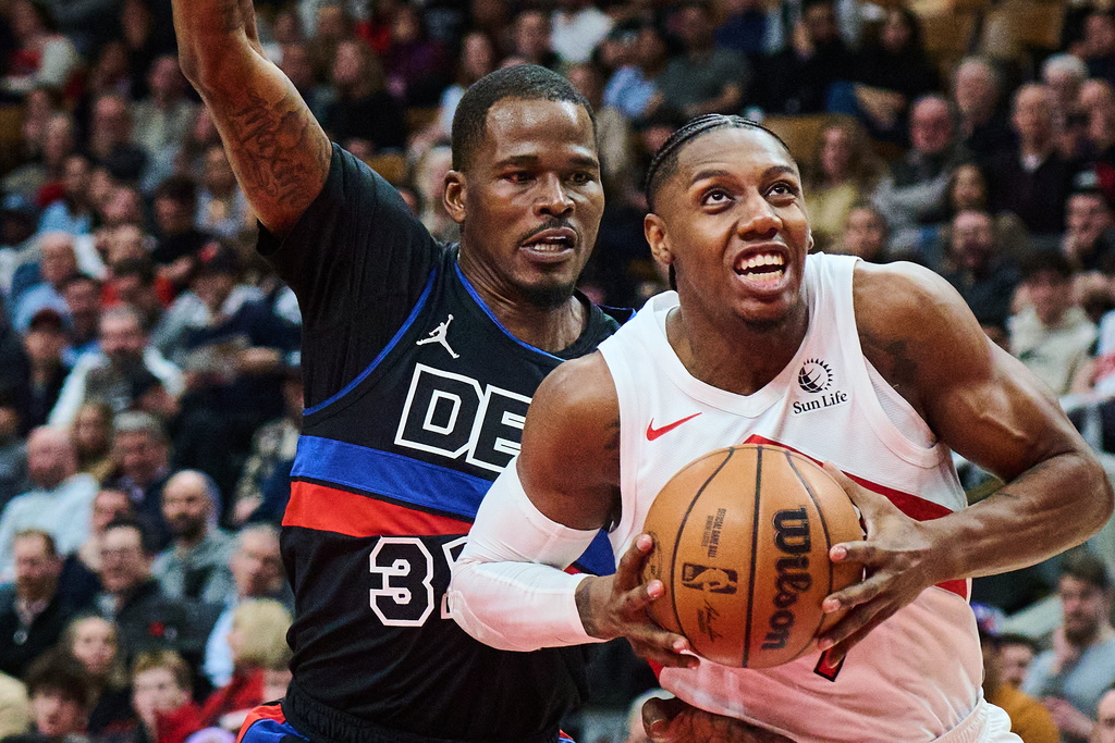 Toronto Raptors' RJ Barrett (9) drives through Detroit Pistons' Javonte Green (31) during the first half of an NBA basketball game in Toronto, Wednesday, Feb. 11, 2026. (Sammy Kogan/The Canadian Press via AP)