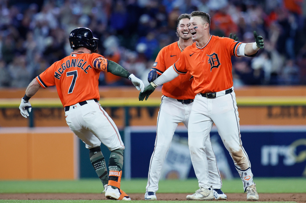 Detroit Tigers' Spencer Torkelson, right, celebrates with Kevin McGonigle (7) and Zach McKinstry, center, after hitting an RBI single to drive in Matt Vierling in the bottom of the ninth inning to beat the Toronto Blue Jays in a baseball game, Friday, May 15, 2026, in Detroit. (AP Photo/Duane Burleson)