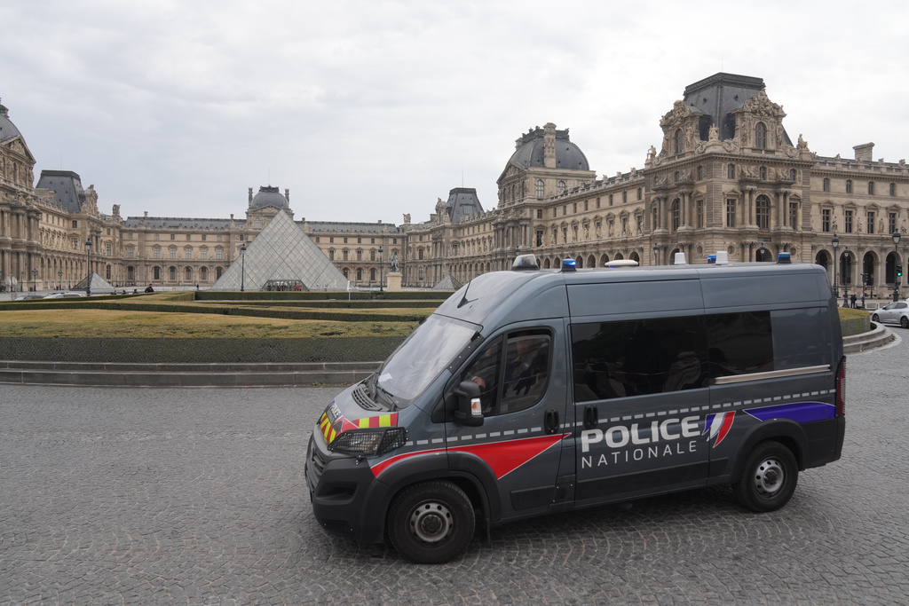 A police van patrols in the courtyard of the closed Louvre museum after a robbery Sunday, Oct. 19, 2025 in Paris. (AP Photo/Thibault Camus)