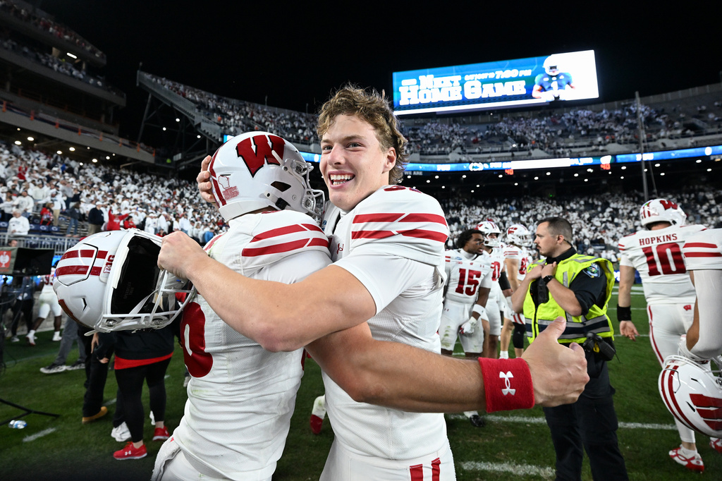 Wisconsin's Sean West, right, celebrates with James Roe, left, after their team defeated Penn State in an NCAA college football game, Saturday, Sept. 26, 2026, in State College, Pa. (AP Photo/Barry Reeger)