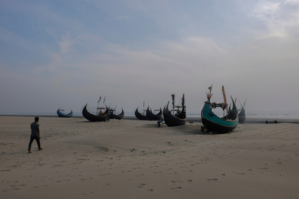 FILE- Fishing boats sit on a beach in Teknaf, Bangladesh, on March 9, 2023. (AP Photo/Mahmud Hossain Opu, File)