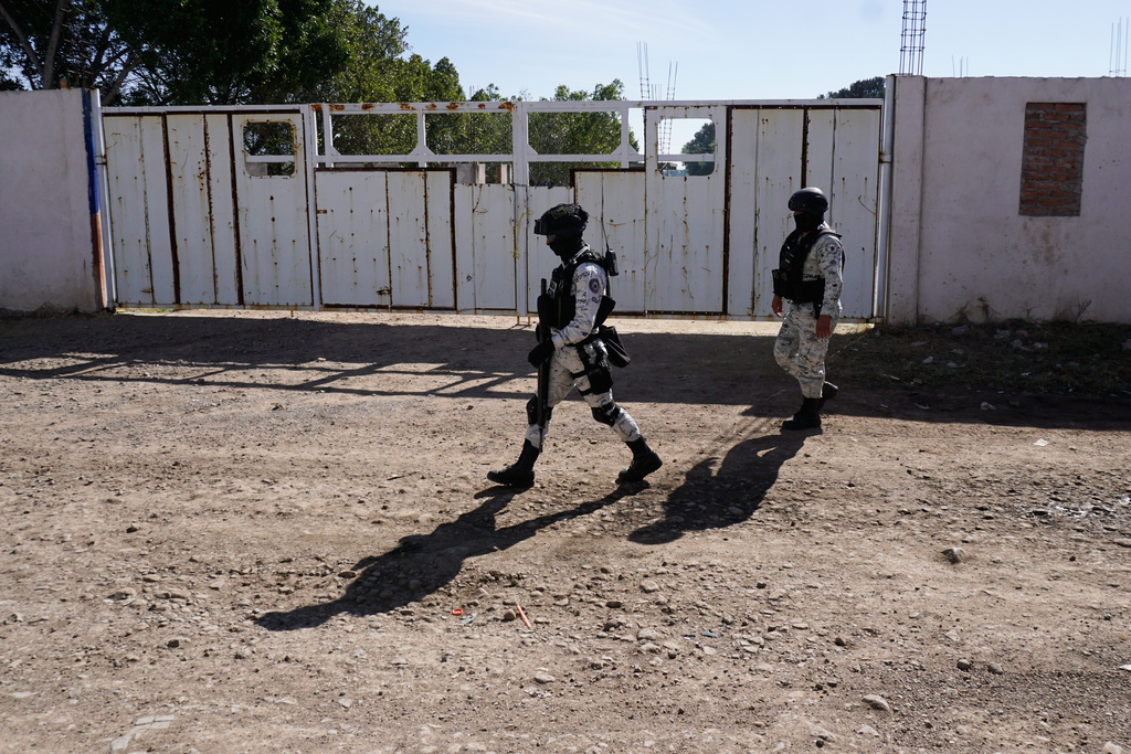 National Guards patrol near a soccer field the day after gunmen opened fire, killing and wounding people, in Salamanca, Mexico, Monday, Jan. 26, 2026. (AP Photo/Mario Armas)