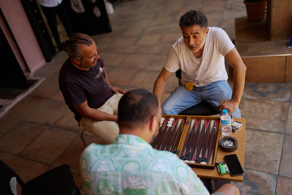 Gold artisans play backgammon during a break in Istanbul's Eminonu commercial district, Thursday, Aug. 6, 2026. (AP Photo/Francisco Seco)